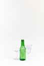 Set of green glass beer bottle and two goblets Royalty Free Stock Photo