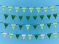 A set of green ribbons on rope in blue background for designing house and office