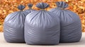Grey Garbage Bags on Ground Surrounded by Colorful Autumn Leaves and Outdoor Natural Background with Soft Lighting Royalty Free Stock Photo