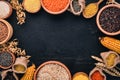 Set of Groats and Grains. Buckwheat, lentils, rice, millet, barley, corn, black rice. On a black background.