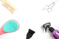Set of hairdressing tools on white background with copy space, combs, scissors, spray and bleach brush on white background, top