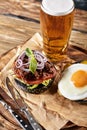 Set of hamburger beer and french fries. A standard set of drinks and food in the pub, beer and snacks. Dark background Royalty Free Stock Photo