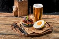 Set of hamburger beer and french fries. A standard set of drinks and food in the pub, beer and snacks. Dark background Royalty Free Stock Photo