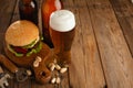 Set of hamburger beer and french fries. A standard set of drinks and food in the pub, beer and snacks. Dark background, fast food Royalty Free Stock Photo