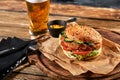 Set of hamburger beer and french fries. A standard set of drinks and food in the pub, beer and snacks. Dark background Royalty Free Stock Photo