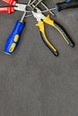 Set of hand tools screwdriver with blue rubber handle pliers home repair copy space Royalty Free Stock Photo