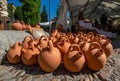 Set of handmade clay and ceramic jugs displayed on the floor of a traditional crafts market in Salamanca. Earthenware drinking jug Royalty Free Stock Photo