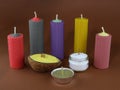 Colored candles made of beeswax and stearin on a brown background. Royalty Free Stock Photo