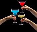 Set of hands holding cocktails isolated on black background