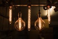 Set of hanging light bulbs with dark storage room background. Retro style Royalty Free Stock Photo