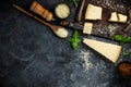 Set of hard cheeses with cheese knives on black stone background. Parmesan. Top view. Free space for your text Royalty Free Stock Photo