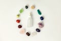 Set of healing gemstones crystals and glass bottle for making crystal elixir in white background