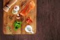 Set of Healthy anticancer food on wooden table. Red salmon fish, broccoli, garlic, milk, pepper and tomatoes scattered