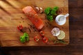 Set of Healthy anticancer food on wooden table. Red salmon fish, broccoli, garlic, milk, pepper and tomatoes scattered