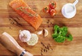 Set of Healthy anticancer food on wooden table. Red salmon fish, broccoli, garlic, milk, pepper and tomatoes scattered