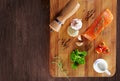 Set of Healthy anticancer food on wooden table. Red salmon fish, broccoli, garlic, milk, pepper and tomatoes scattered