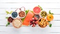 A set of healthy food. Fish, nuts, protein, berries, vegetables and fruits. On a white background. Top view. Royalty Free Stock Photo