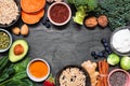 Set of healthy super food ingredients. Top view frame on a slate background. Copy space. Royalty Free Stock Photo