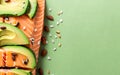 Set of healthy food for keto diet on green background. Fresh raw salmon steak with flax seeds, avocado, nuts and seeds on green Royalty Free Stock Photo