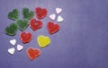 Set of heart shaped jelly candies isolated on blue background. Top view, soft selective focus. Colorful candy marmalade. Candied Royalty Free Stock Photo