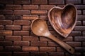 Set of heartshaped wood bowl and spoon on wooden backcloth Royalty Free Stock Photo