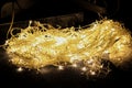 A set of heavily tangled Christmas lights on the floor