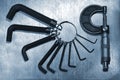 Set of hex allen keys and micrometer on steel background Royalty Free Stock Photo