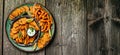 Set of homemade baked orange sweet potato fries with lime and herbs on plate. Long banner format. top view Royalty Free Stock Photo