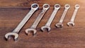 Set of horn and socket wrenches on a wooden background