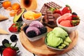 Set of ice cream scoops of different colors and flavours with berries, chocolate and fruits Royalty Free Stock Photo