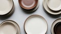 The set includes plates and bowls in neutral tones primarily beige and brown Royalty Free Stock Photo