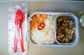 Set of inflight meal in a box, on the folding table in economy class. Feeding the passengers of Asian food on the plane . Royalty Free Stock Photo