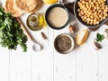 Set of ingredients for cooking homemade traditional hummus on a white wood background. Top view