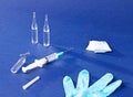 Set for injections - syringe, ampoules, and an alcohol wipe on a blue background Royalty Free Stock Photo