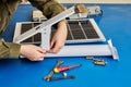 Customer assembles solar street light from flat pack, starting with mounting bracket. Royalty Free Stock Photo