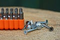 A set of iron bits for a screwdriver in a box and a bunch of screws on a wooden board Royalty Free Stock Photo