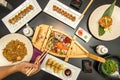 Set of Japanese dishes and sushi on black table. Salmon nigiri, red tuna sashimi, california roll, wakame seaweed salad, parlor Royalty Free Stock Photo