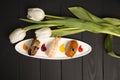Set of Japanese Nigiri Sake Sushi with salmon, tiger shrimp and eel with white tulips on background. Top view Royalty Free Stock Photo