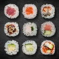 Set Japanese rolls assortment, hosomaki close-up are served on a stone board. Vertical top view from above Royalty Free Stock Photo