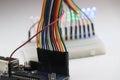 Set of jumper wires connected to a microcontroller board that completes the circuit with Breadboard and LED showing prototyping Royalty Free Stock Photo