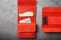 Set of key holder wallet with money and electronic cards and a key holder made of genuine red leather, handmade on a dark Royalty Free Stock Photo
