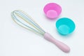 Set of kitchen accessories for baking: silicone moulds for cupcakes of pink and blue colors and a crown for stirring ingradients.