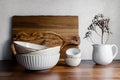 Set of kitchen ceramic tableware and wooden cutting boards on a table Royalty Free Stock Photo