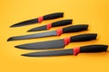 Set kitchen knives with a black handle on yellow background Royalty Free Stock Photo