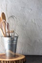 Set of kitchen utencil store in a tin on round wood board Royalty Free Stock Photo