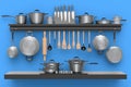 Set of kitchen utensil, stewpot, frying pan and chrome cookware hanging on shelf Royalty Free Stock Photo