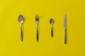 a set of kitchenware utensil cutlery, knife, spoon and fork isolated on the colorful table Royalty Free Stock Photo
