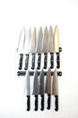 Set of knifes are hanging on a kitchen wall. Royalty Free Stock Photo