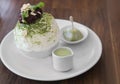 Set of Korean Green tea Bingsu, sweetened condensed milk dessert, daifuku and red bean paste, serving on white ceramic plate. Unhe