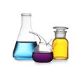 Set of lab glassware with color liquids  on white. Solution chemistry Royalty Free Stock Photo